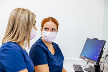 Dental professionals discussing patient care at clinic