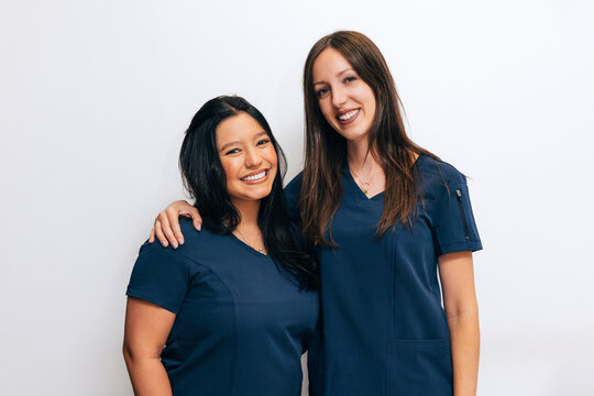 Friendly dental clinic team in professional uniforms
