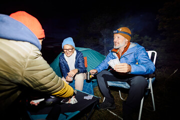 Poker game in the camp by night