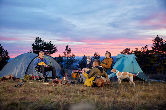 Friends are camping at sunset