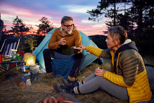 Man and woman shares snacks at the camp