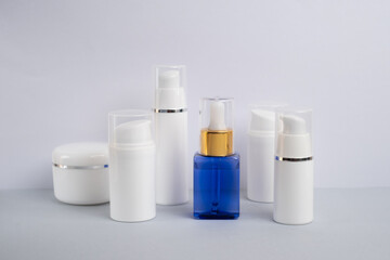 Container for cream, shampoo, toiletries, spa. Unbranded white plastic bottles. Bottle with a dispenser for cosmetic products. Skin care and beauty concept. Mockup style, copy space  