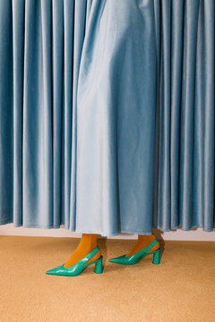 Stylish Woman in Teal Heels and Blue Velvet Skirt
