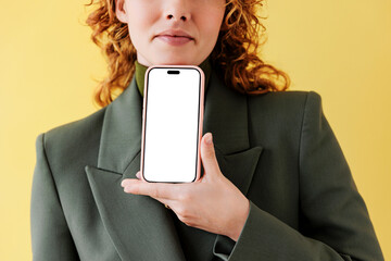 Woman showing smartphone with blank screen 