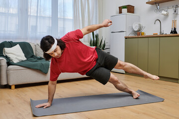 Young man performs an engaging home workout routine in modern apartment