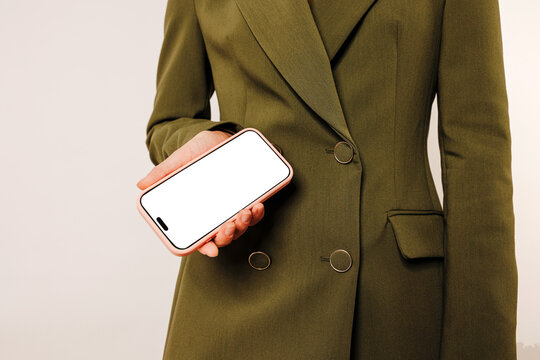 Woman showing smartphone with blank screen in hand