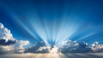the solar shining through the clouds in a blue sky with beams of mild coming from the middle of the clouds