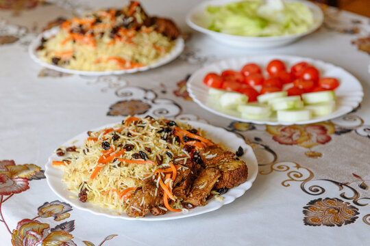 Table set for lunch with traditional Kabul pilaf and salad