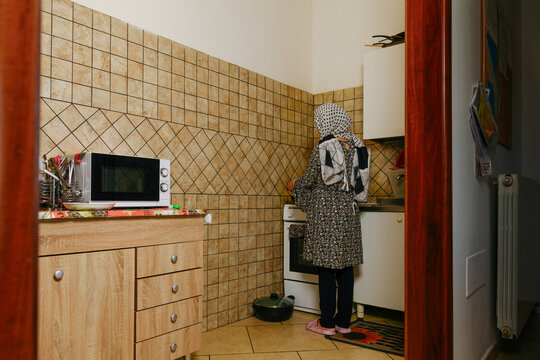 Afghan woman cooking at the kitchen
