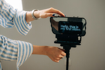 Anonymous woman adjusting teleprompter for video recording sessi