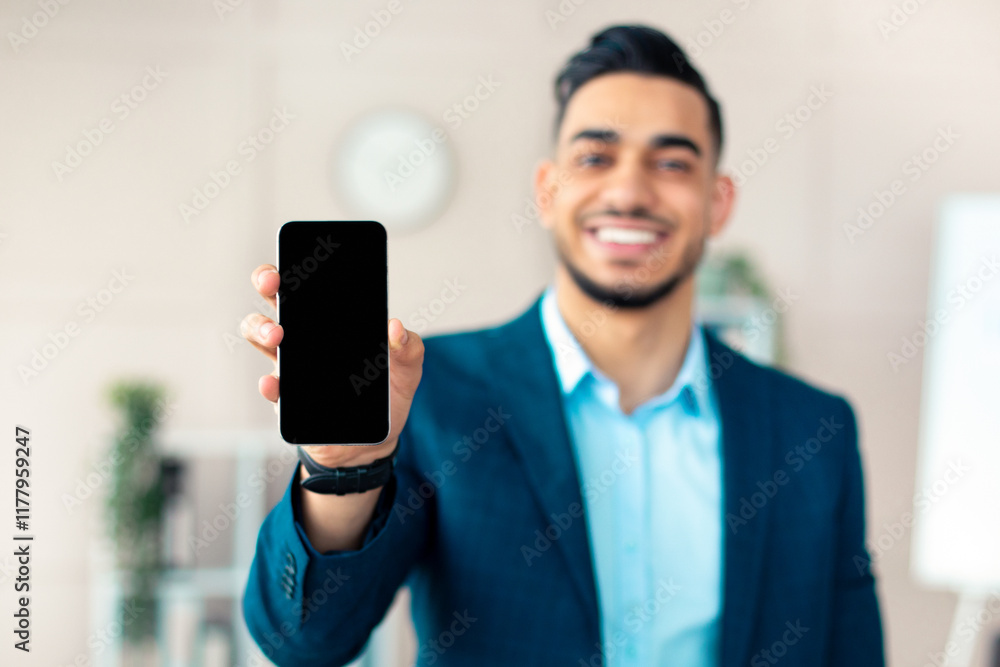 Aufkleber positive arab businessman holding smartphone with empty screen at office, mockup for mobile app or w