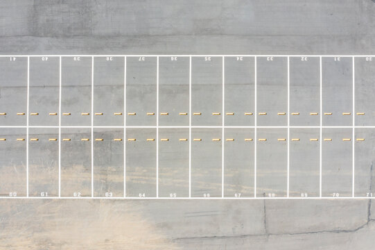 Aerial View of Empty Parking Lot with Marked Spaces