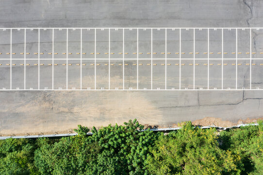Aerial View of Empty Parking Lot with Greenery Border