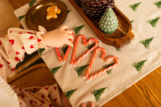 A child arranges candy on the holiday table