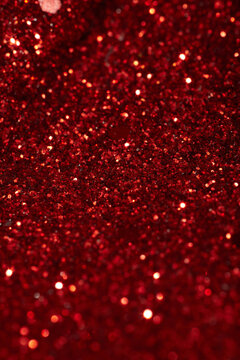 Sparkling red glitter background with bright highlights