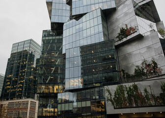 Modern Glass Office Building with Greenery Incorporated Design