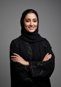 Elegant Emirati woman smiling confidently in traditional abaya with folded arms