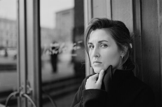 Reflective Woman Stares Down City Street