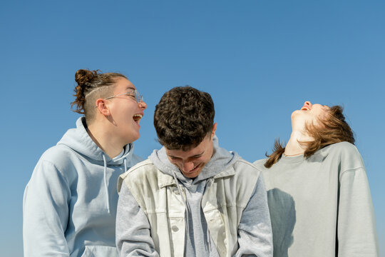 Laughing three guys having fun outdoors 