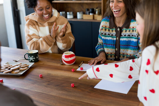 Playing dice game in kitchen