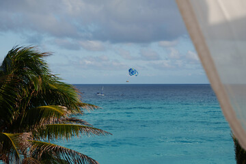 Experience a tropical paradise with thrilling parasailing over vibrant turquoise waters