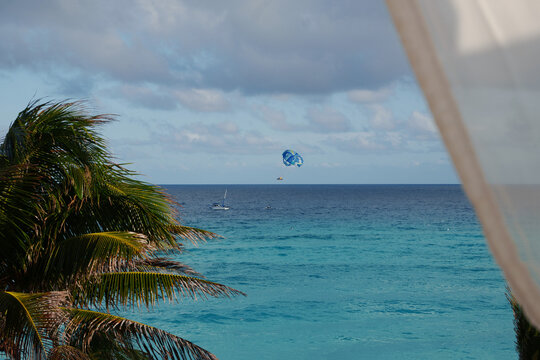 Experience a tropical paradise with thrilling parasailing over vibrant turquoise waters