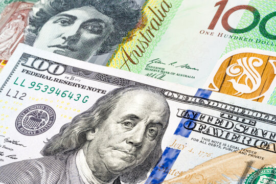 US 100 dollars and Australian 100 dollars banknotes. International trade concept