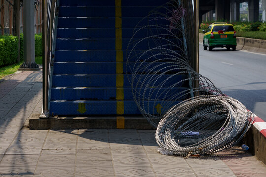 Barbed wire on the floor of an overpass bridge