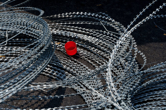 Red spray can cap on barbed wire