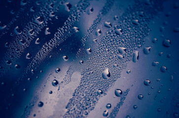 Exterior window condensation in St. Augustine Florida, moody atmospheric blue background