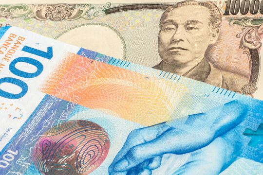 Japanse 10000 yen and Swiss 100 franc banknotes. International trade concept