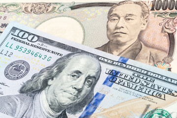 100 US dollar and 10000 yen banknotes. International trade concept
