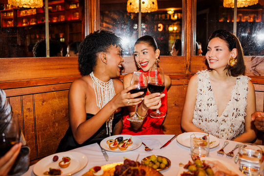Elegant women celebrating New Year's eve at fancy restaurant ugc