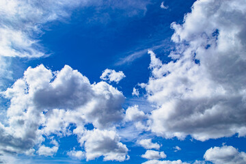 Magnificent cumulus clouds high in blue sky