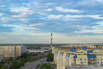 Top view of the town with many multi-storey buildings under a cloudy sky