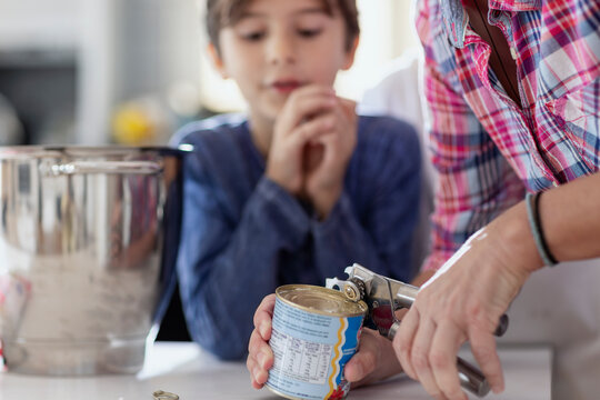 Children eagerly helping with dessert in a modern kitchen.