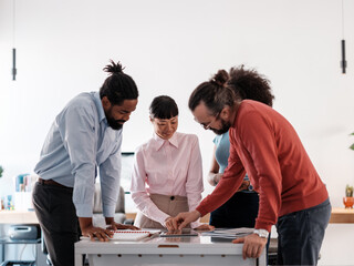 Diverse Team Collaborating on a Project in Modern Office