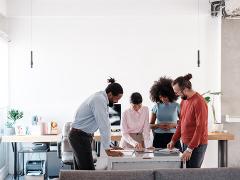 Diverse Team Collaborating on a Project in Modern Office Setting