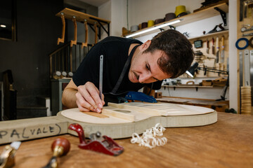 Young Luthier Crafting a Spanish Flamenco Guitar in Workshop