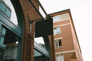 Black Sign on Brick Building