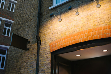 Lit Sign on Brick Wall