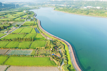 Aerial View of Farmland and Retention Pond with Winding Road