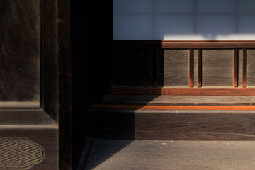 The grain and shadow of a wooden door frame.