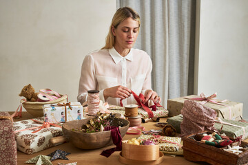Wrapping Christmas gifts with vintage paper, ribbons and bows