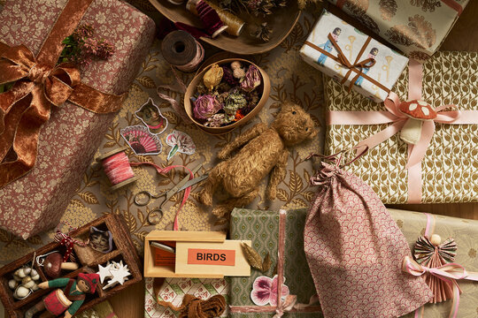 Wrapping Christmas gifts with vintage paper, ribbons and bows