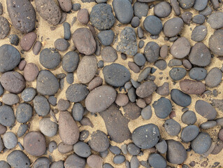 Pattern of pebbles and sand at Famara beach, Lanzarote island, Spain