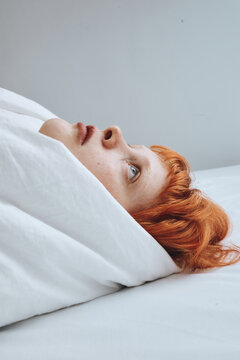 Woman Resting in White Sheets