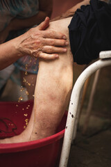 Caring for an elderly person. Washing feet. Nurse. Love for old relatives. Washing with herbal...