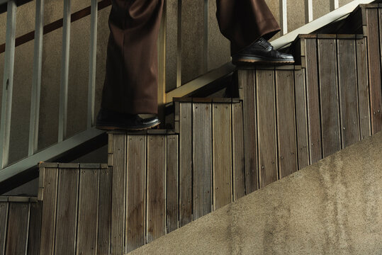 Fashion model going up the wooden stairs