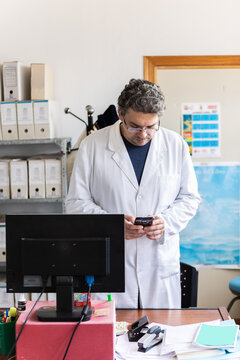 Archivist checking his phone